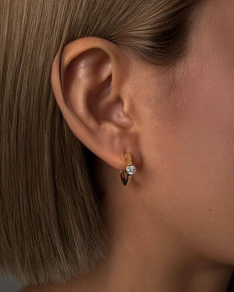 Woman wearing small rose gold stud earrings